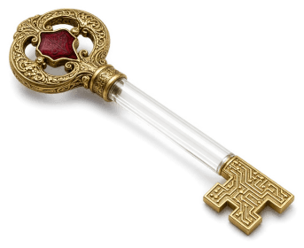 A glass-and-brass key with a red enamel bow and a circuit-pattern bit